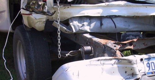 Close up photo of a damaged truck bumper.